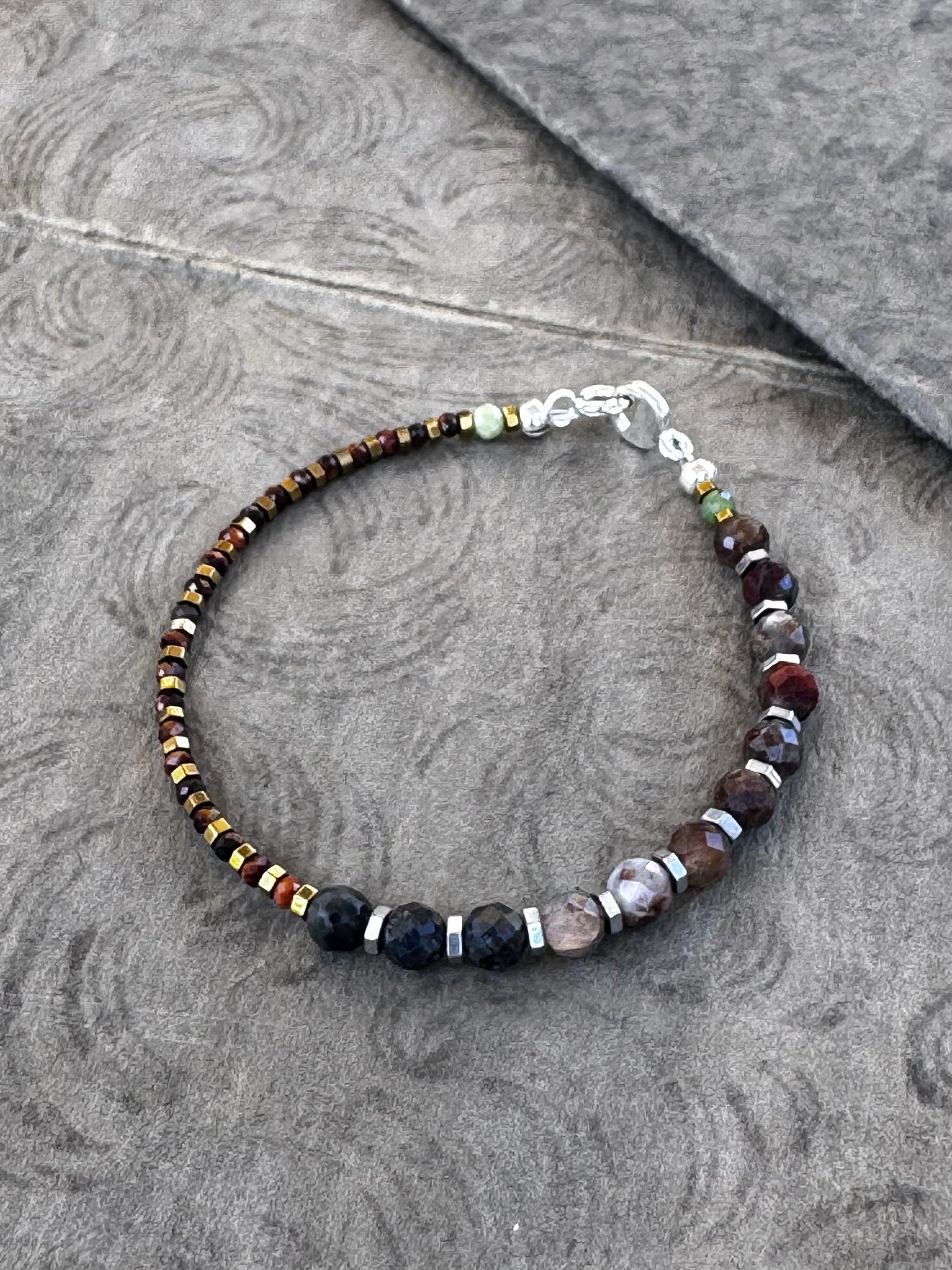 Beaded bracelet on a textured gray surface