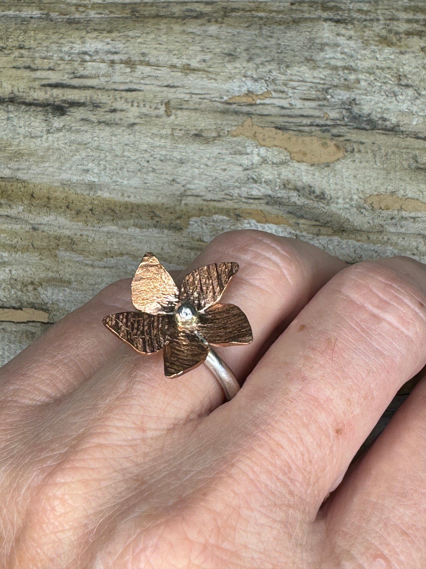 Lilian ring worn on hand, floral copper and sterling silver centerpiece on sterling band, handmade statement jewelry