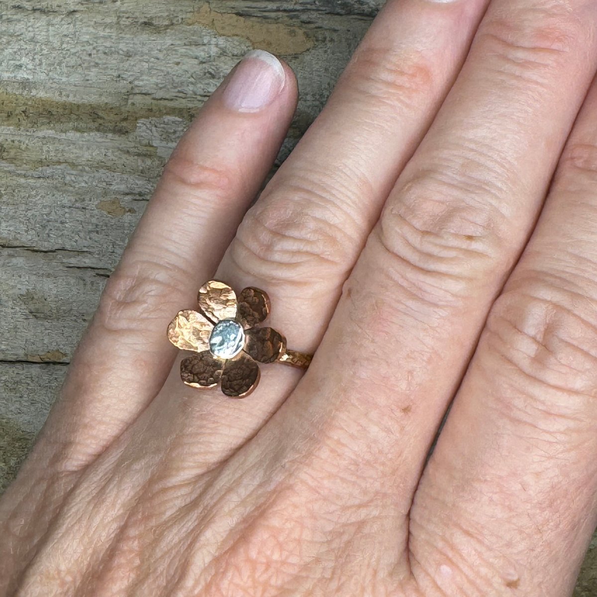 Rustic mixed metal floret ring worn on hand, showcasing artisan design and lightweight fit, handmade in size 6
