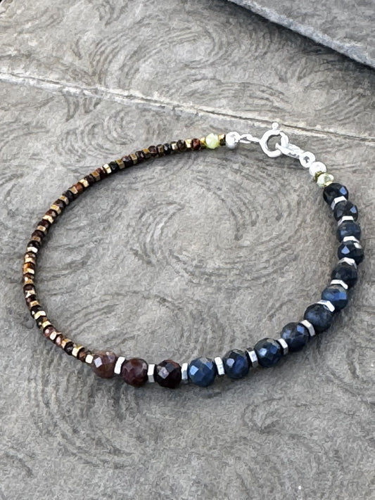 Bracelet with Pietersite and Red Tiger Eye beads on a textured surface