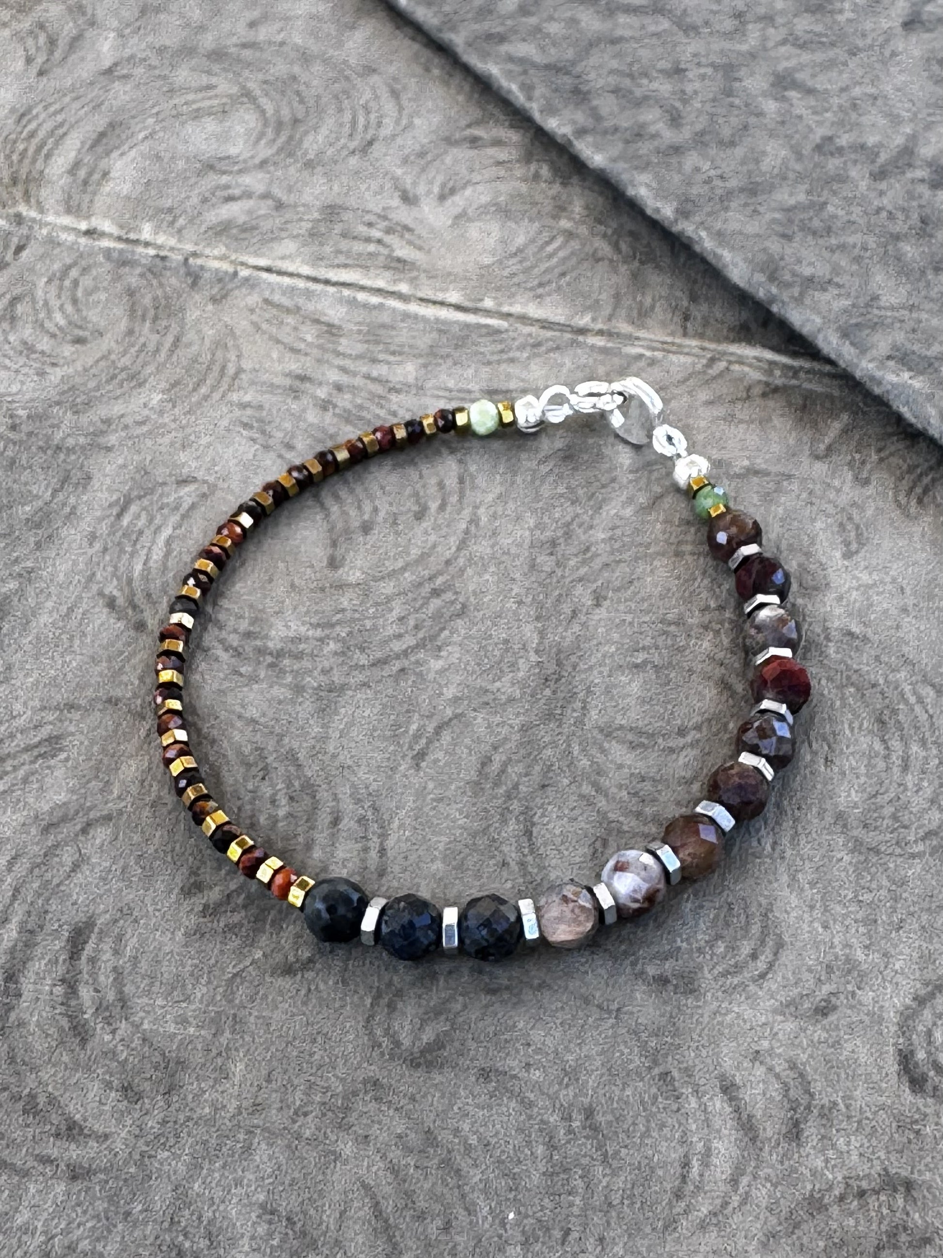 Beaded bracelet on a textured gray surface