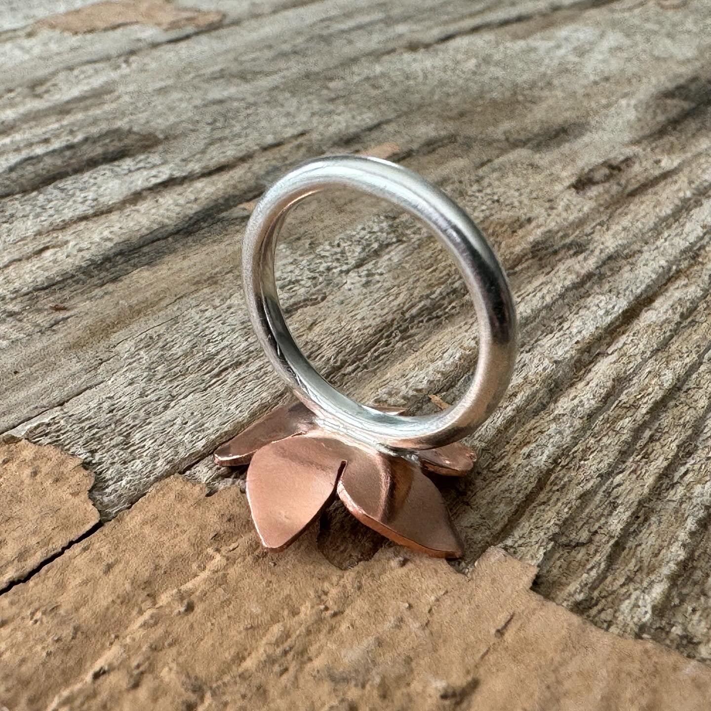 Detailed view of handforged sterling silver ring band with copper floret, handmade in california