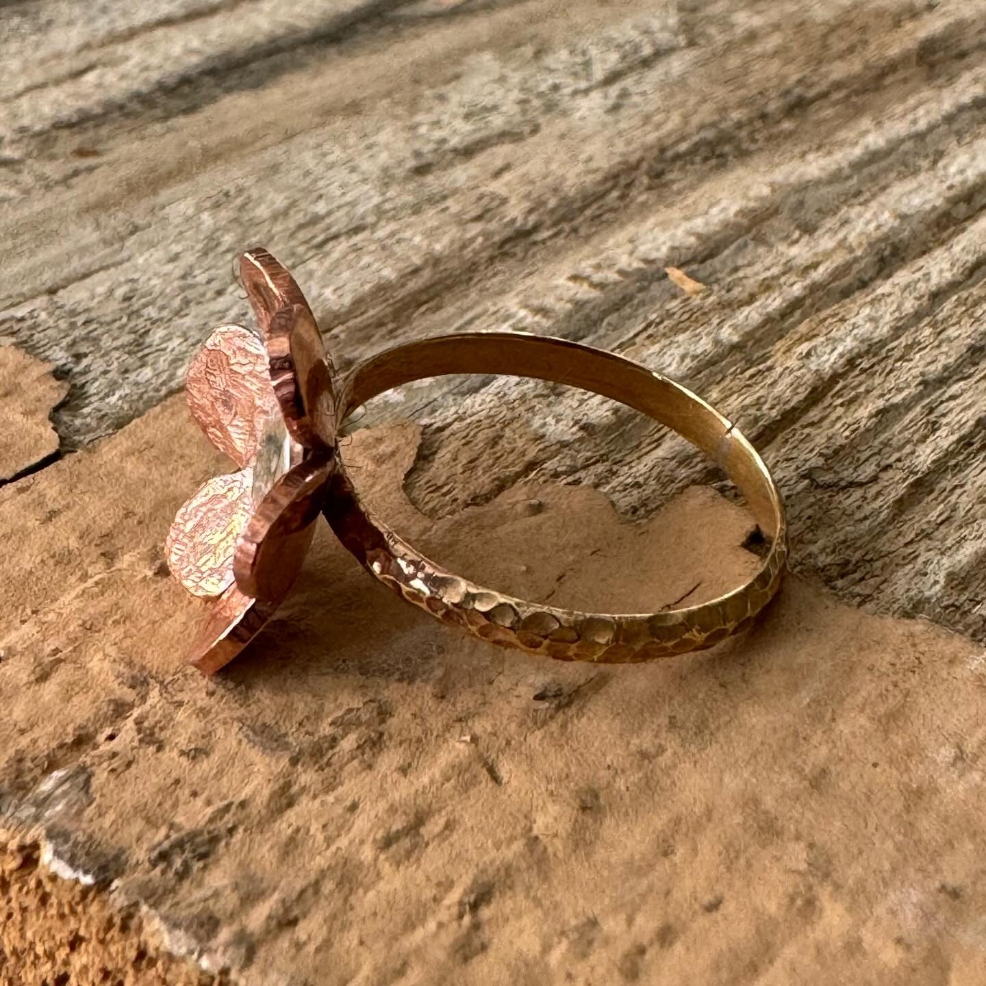 Close-up of textured copper and sterling silver floret centerpiece on brass ring band, part of The Floret Collection