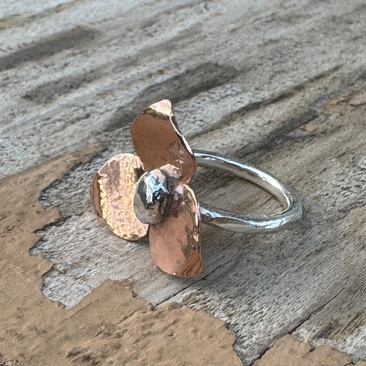 Handmade Marion floret ring with copper and sterling silver flower design on textured sterling silver band
