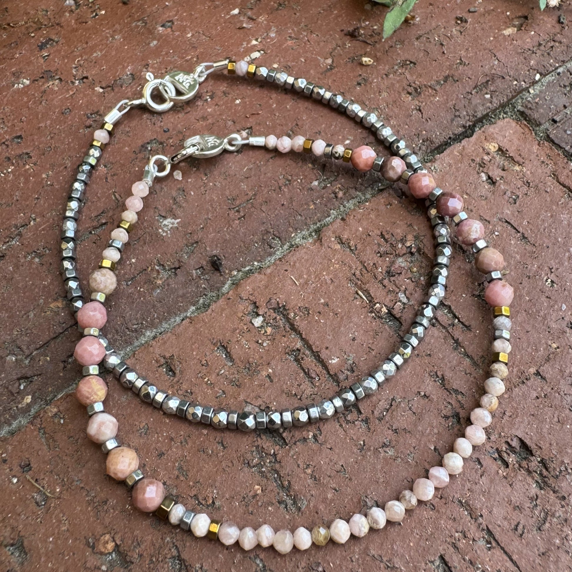 Handcrafted gemstone bracelet pair featuring Rodochrosite and Hematite beads. Inspired by Silverton, Colorado’s mining heritage.