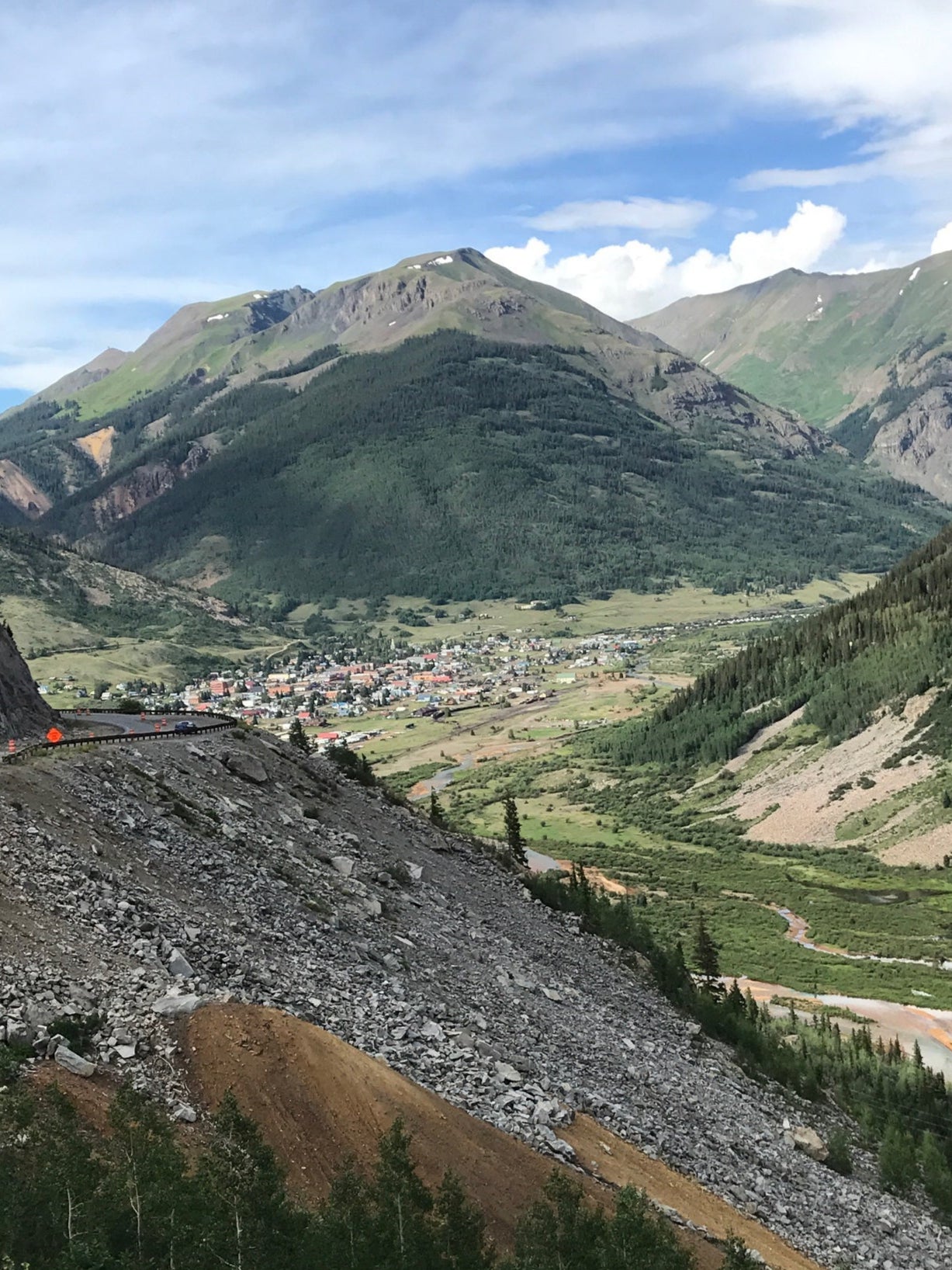 Scenic view of Silverton, Colorado, taken from the roadside with historic buildings and mountainous landscape in the background.