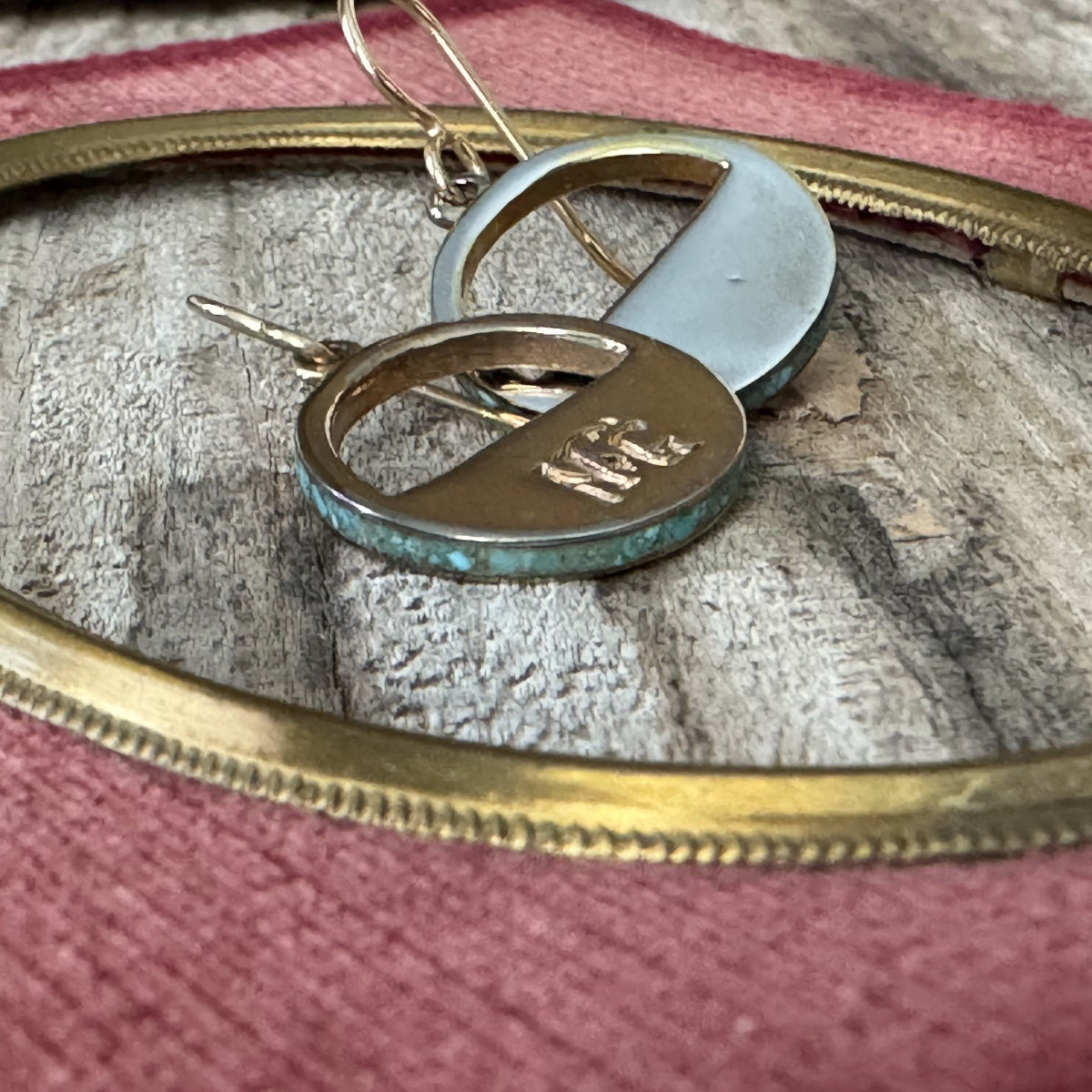 Close-up of Belle Starr rustic patina earrings with turquoise inlay, highlighting handcrafted details and weathered rustic finish