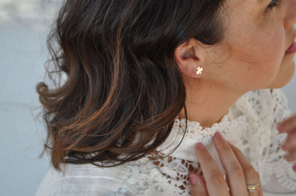 Profile of  model wearing a Pharo Club sterling silver stud earring paired with a crochet top.